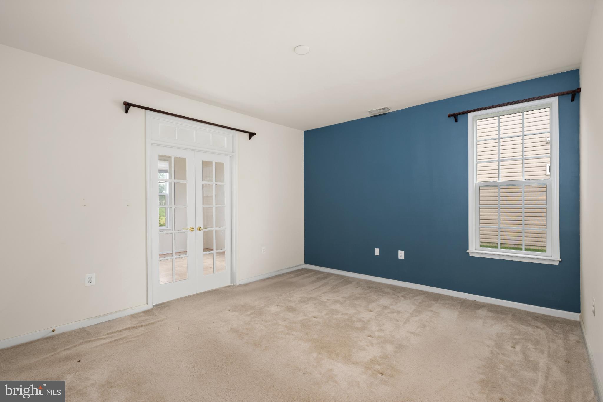 12 Harlequin Loop Bridgeville, DE 19933 - Photo 11 of 47 Spacious room with a bold accent wall.