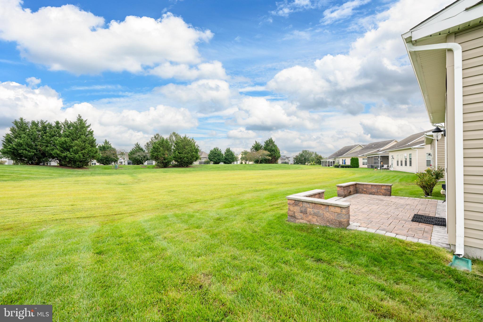 12 Harlequin Loop Bridgeville, DE 19933 - Photo 30 of 47 Expansive green space under a bright sky.