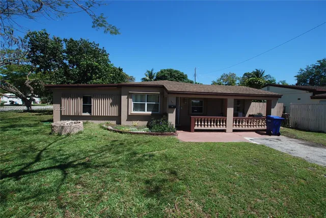 front view of a house with a patio yard and deck