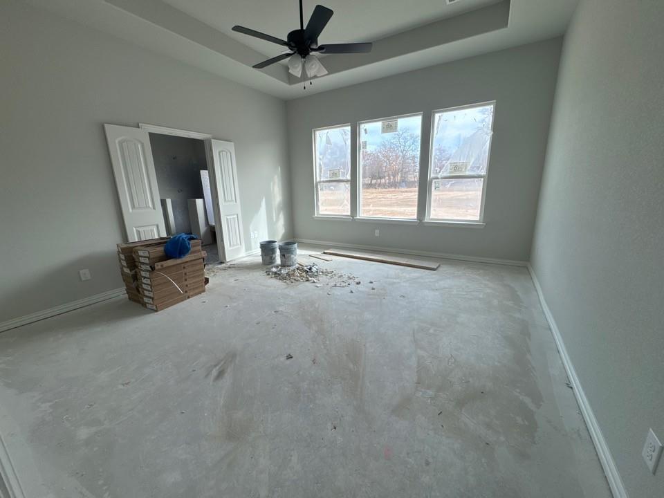 152 Oak Grv Way Springtown, TX 76082 - Photo 7 of 10 Unfurnished bedroom with a raised ceiling and ceiling fan