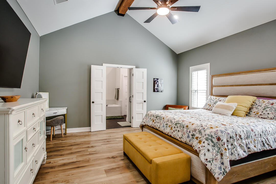 4106 124th Street Lubbock, TX 79423 - Photo 14 of 30 a bedroom with a bed and a flat screen tv