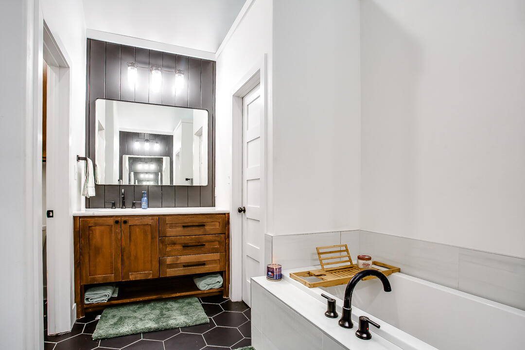 4106 124th Street Lubbock, TX 79423 - Photo 16 of 30 a bathroom with a sink and a mirror