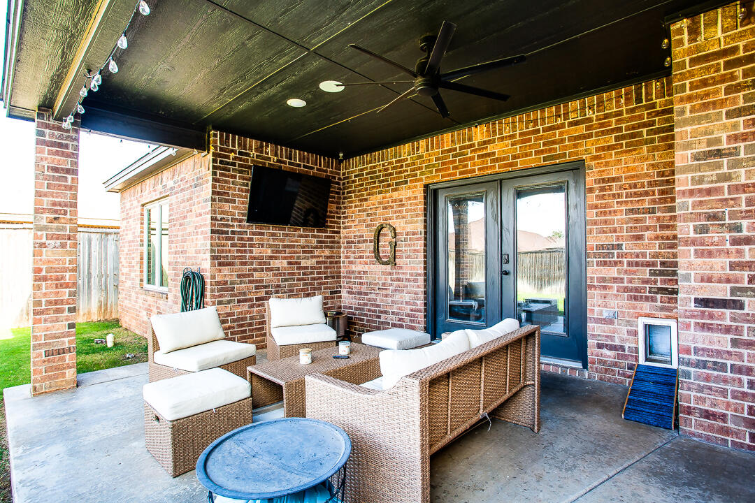 4106 124th Street Lubbock, TX 79423 - Photo 28 of 30 a outdoor space with patio couches and a fireplace