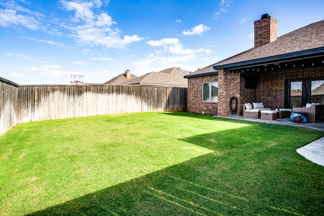 4106 124th Street Lubbock, TX 79423 - Photo 29 of 30 a backyard of a house with table and chairs