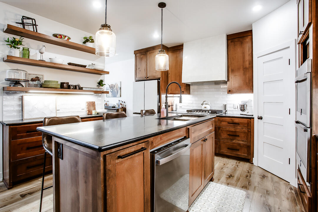 4106 124th Street Lubbock, TX 79423 - Photo 7 of 30 a kitchen with a sink a stove and chairs