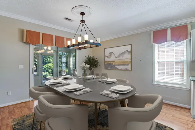 a view of a dining room with furniture wooden floor and chandelier