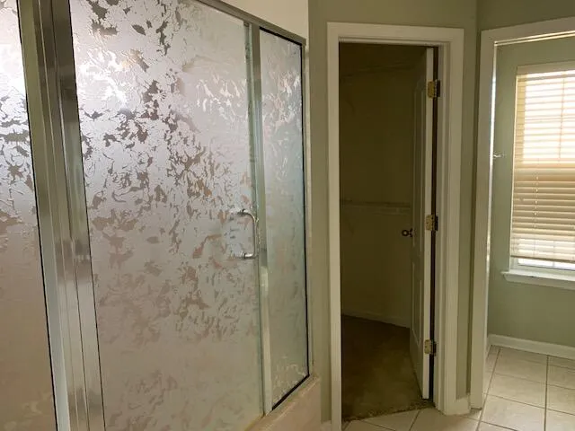 a bathroom with a shower and a sink