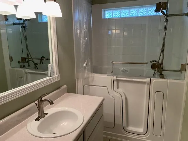 a bathroom with a sink a toilet and a mirror