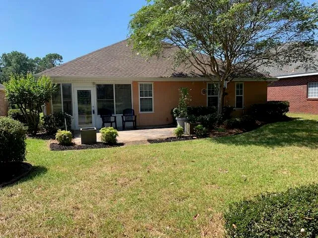 a view of a house with a yard and a garden