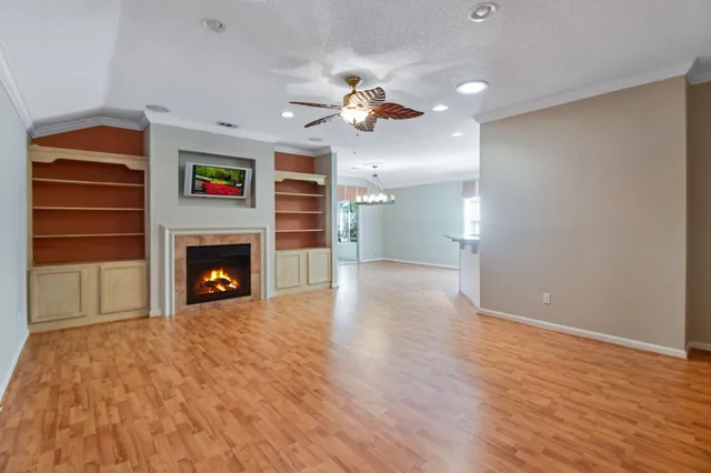 a view of empty room with a fireplace and fan