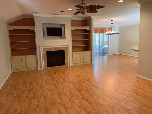 a view of a livingroom with a fireplace cabinet and a window