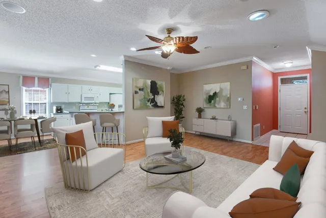 a living room with furniture and a dining table with kitchen view