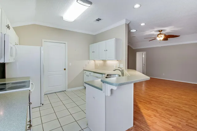 a kitchen with a sink cabinets and appliances