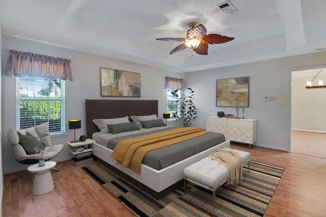 a bedroom with a bed and wooden floor