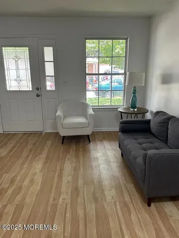 a living room with furniture and a large window