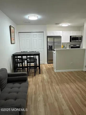 a view of kitchen with furniture and wooden floor