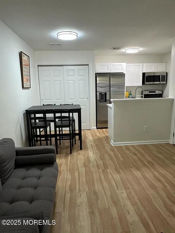 28 Delavan Court New Brunswick, NJ 08901 - Photo 2 of 10 a view of kitchen with furniture and wooden floor