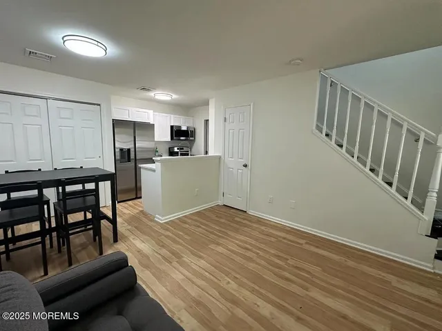 a view of kitchen with furniture and wooden floor