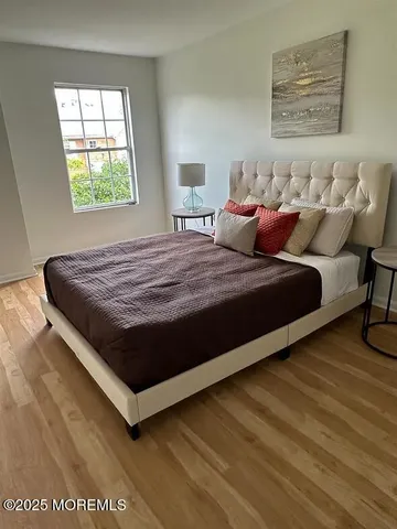 a bed sitting in a bedroom next to a window