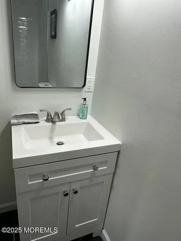 a bathroom with a sink a mirror and vanity