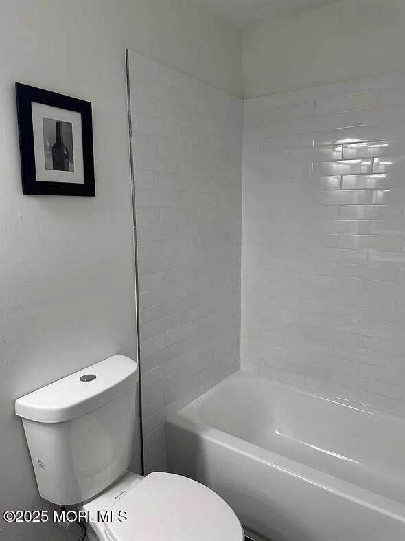 28 Delavan Court New Brunswick, NJ 08901 - Photo 10 of 10 a white toilet sitting next to a bath tub