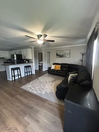 a living room with furniture and a wooden floor