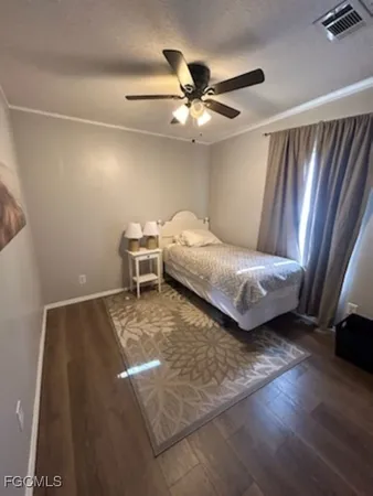 a bedroom with a bed and a ceiling fan