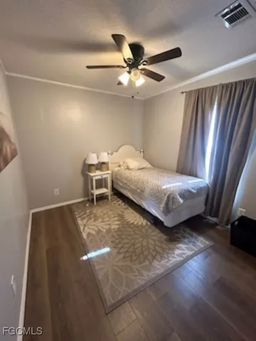 a bedroom with a bed and a ceiling fan
