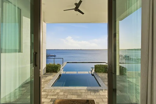 an aerial view of a house with swimming pool garden and patio