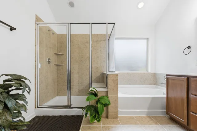 a bathroom with a bathtub and a shower