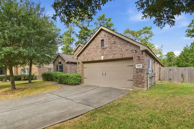 a view of a house with a yard and garage