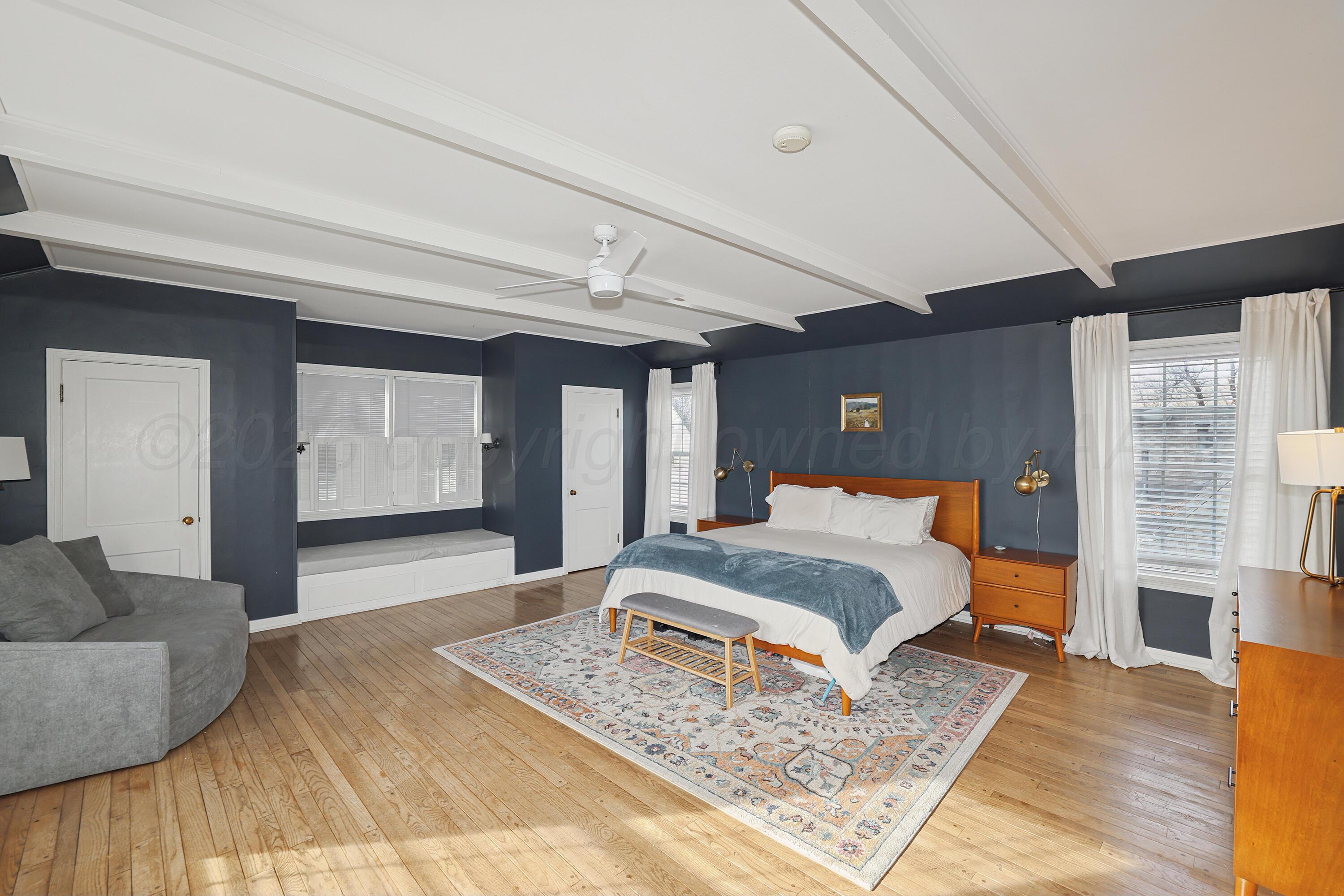 2102 South Hayden Street Amarillo, TX 79109 - Photo 18 of 37 a bedroom with a large bed and a couch