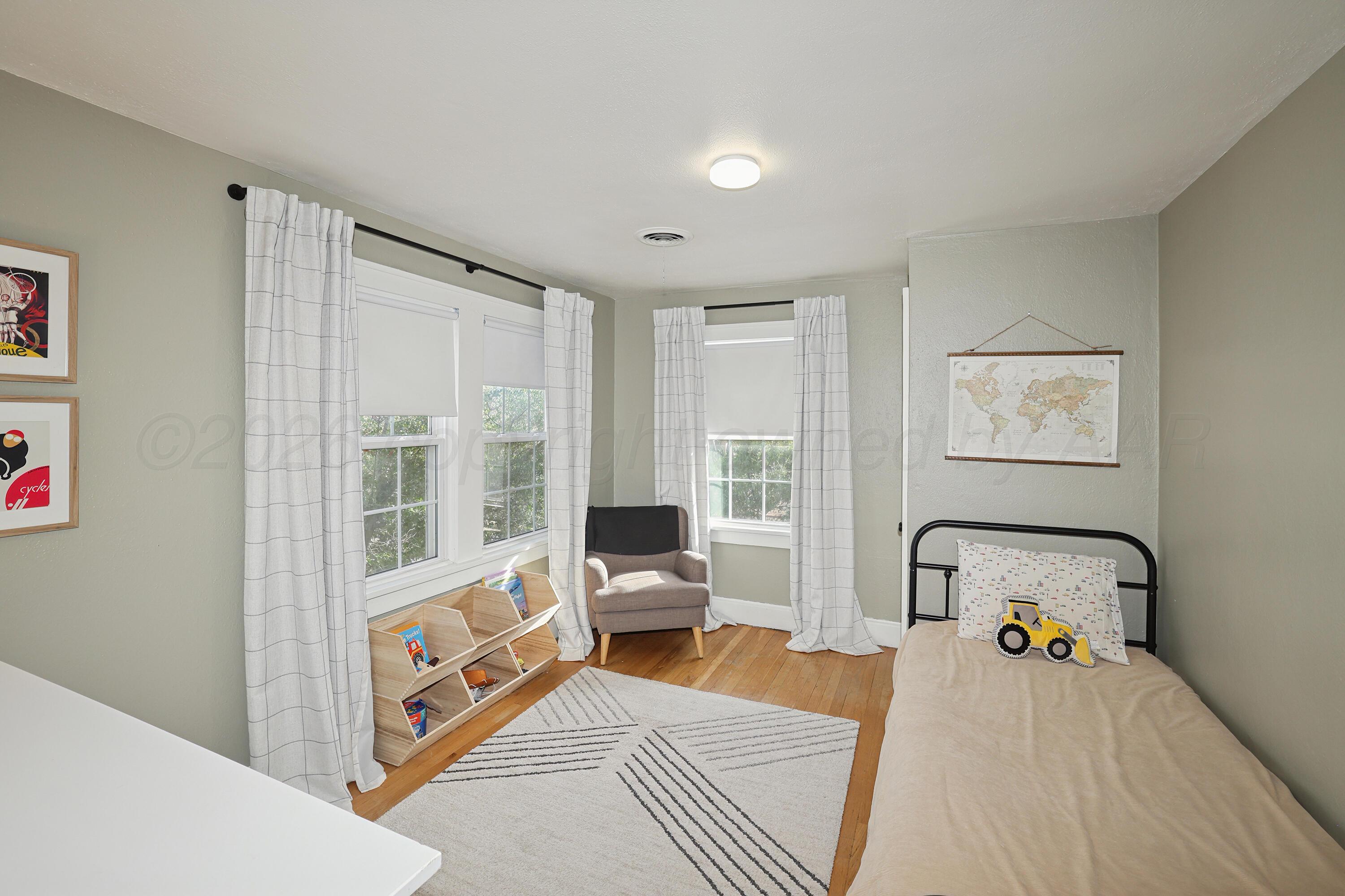 2102 South Hayden Street Amarillo, TX 79109 - Photo 25 of 37 a bedroom with a bed and wooden floor