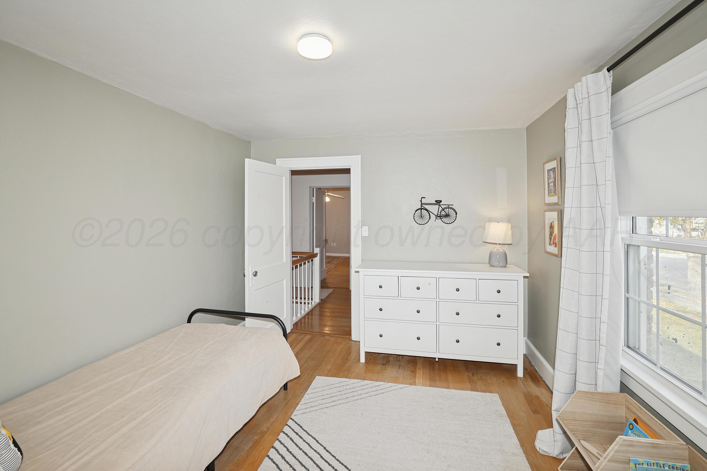 2102 South Hayden Street Amarillo, TX 79109 - Photo 26 of 37 a bedroom with a bed and wooden floor