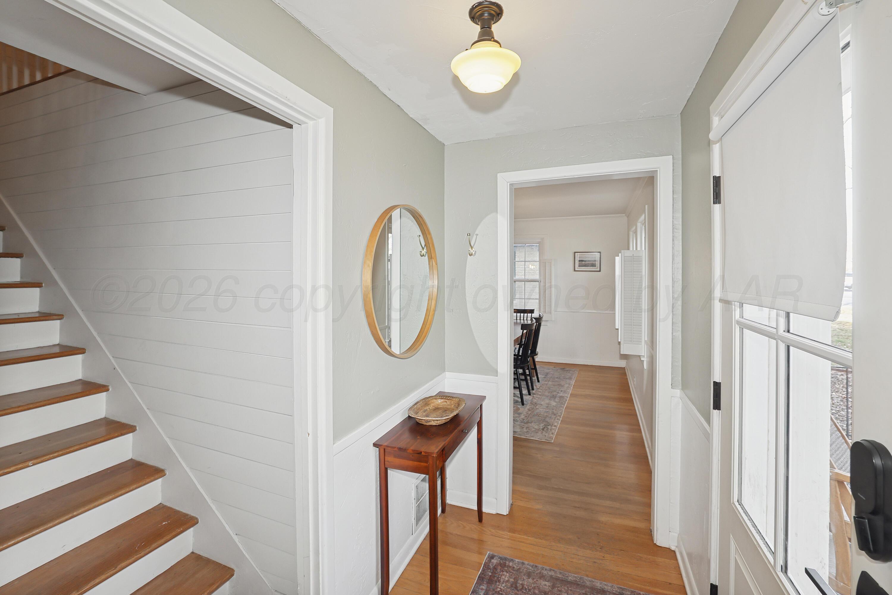 2102 South Hayden Street Amarillo, TX 79109 - Photo 3 of 37 a view of a hallway with wooden floor and staircase
