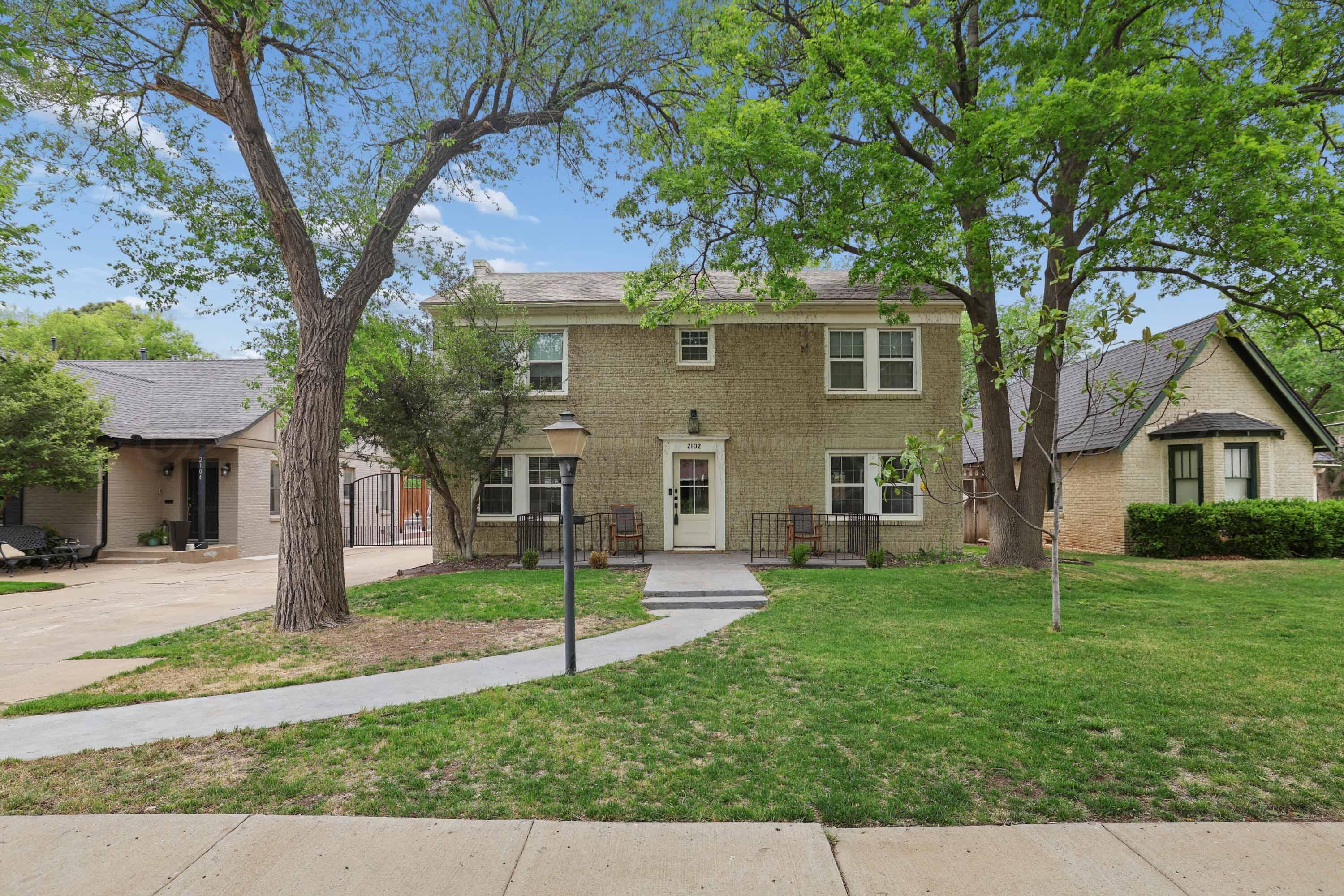 2102 South Hayden Street Amarillo, TX 79109 - Photo 37 of 37 a view of a yard in front of a house with plants and large tree
