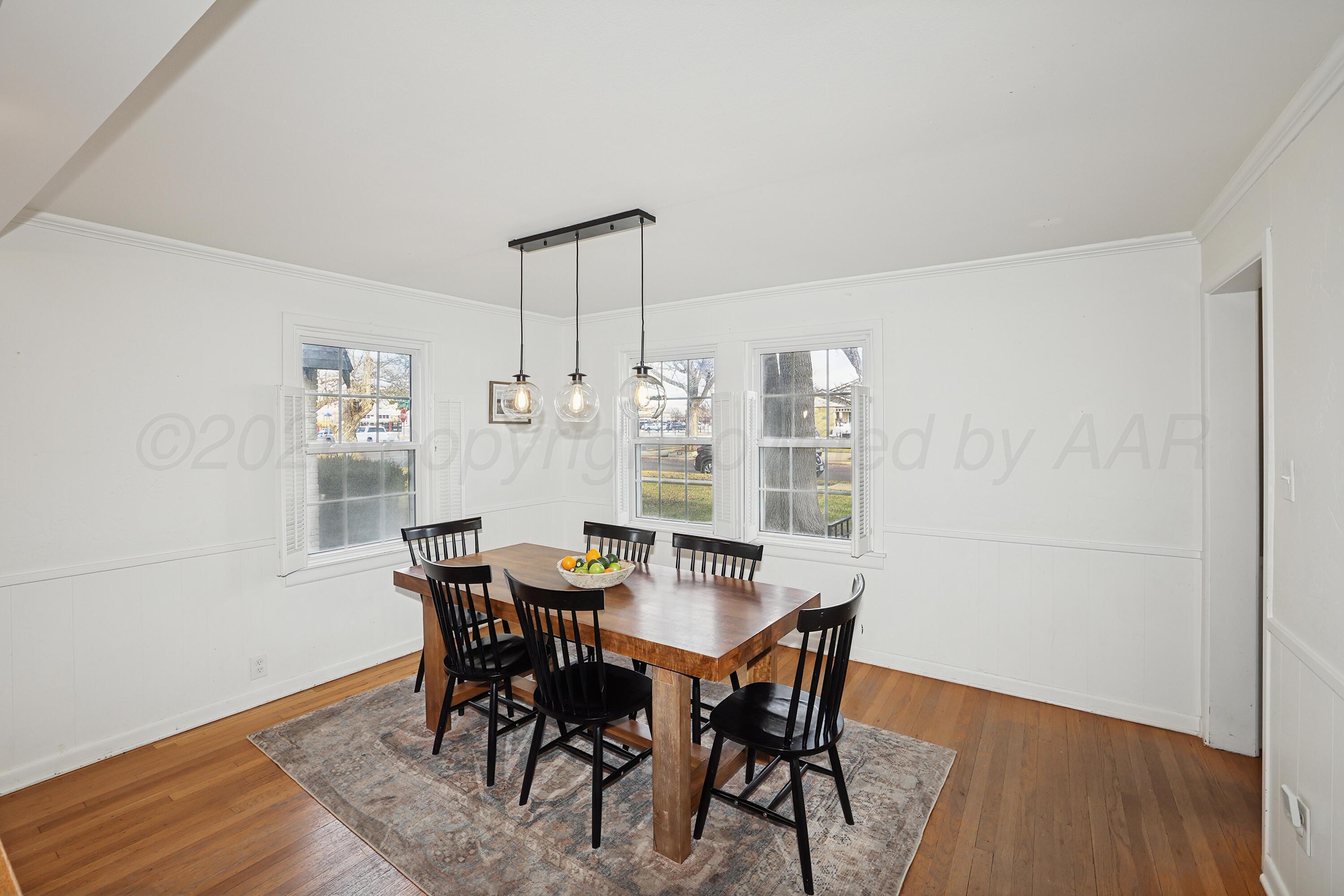2102 South Hayden Street Amarillo, TX 79109 - Photo 7 of 37 a view of a dining room with furniture and wooden floor
