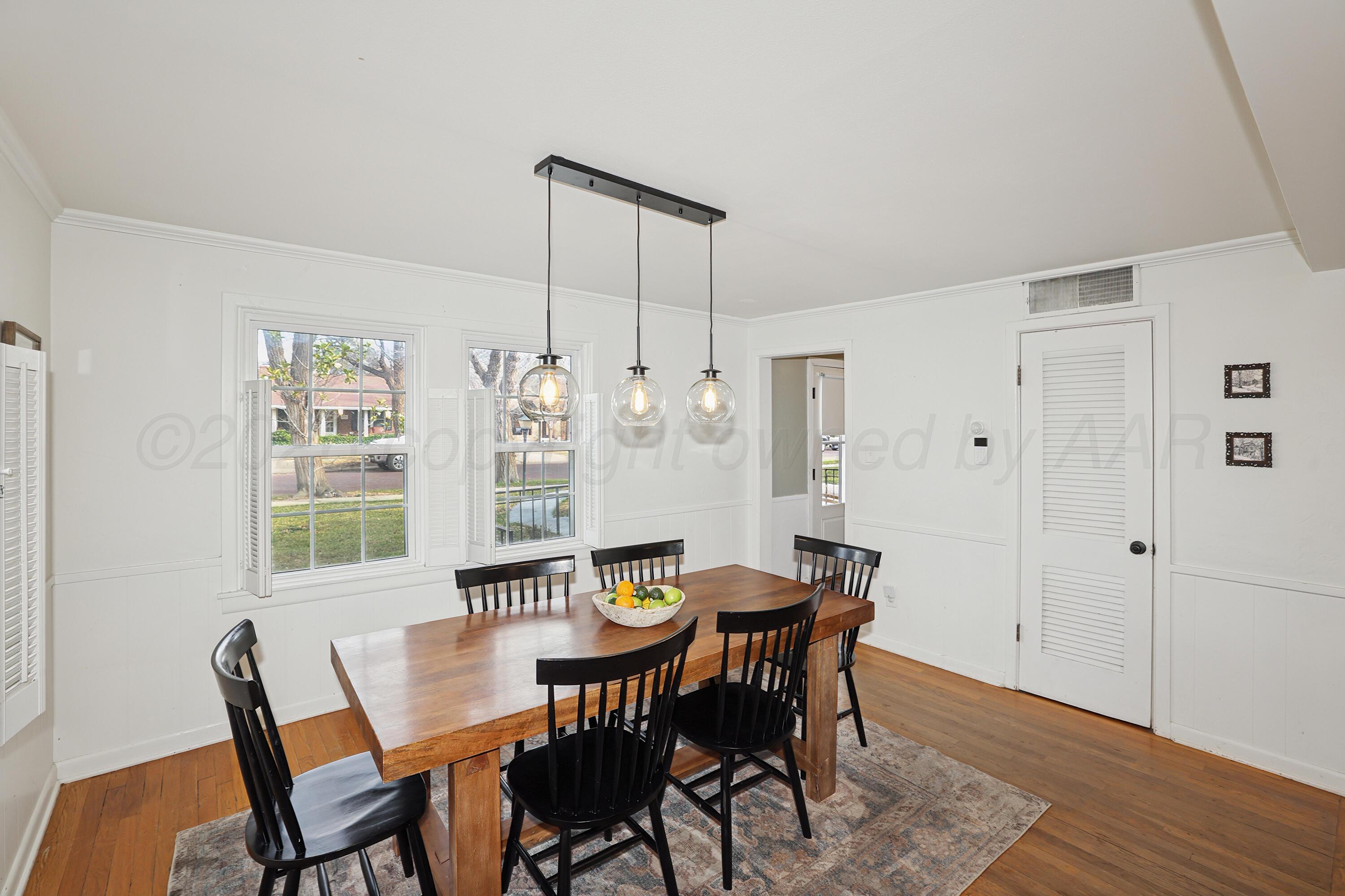 2102 South Hayden Street Amarillo, TX 79109 - Photo 8 of 37 a view of a dining room with furniture window and wooden floor