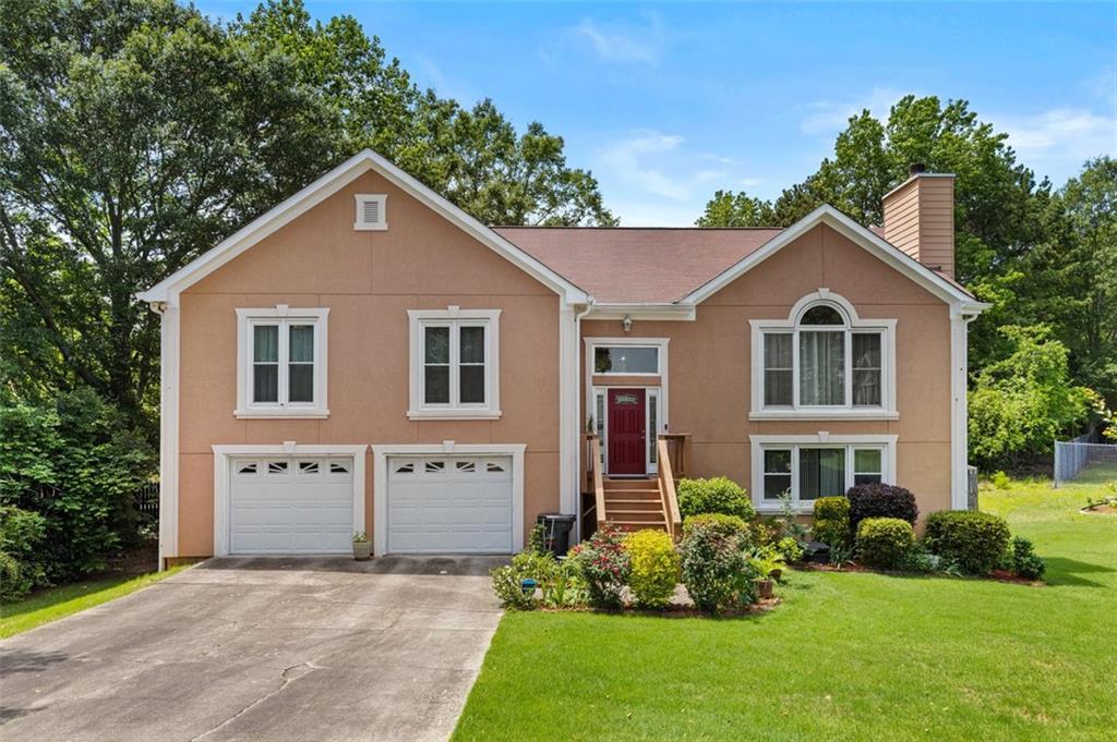920 Highfield Court Lawrenceville, GA 30043 - Photo 1 of 1 a front view of a house with a yard and potted plants