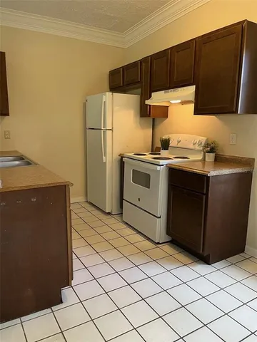 a kitchen with a refrigerator sink and stove
