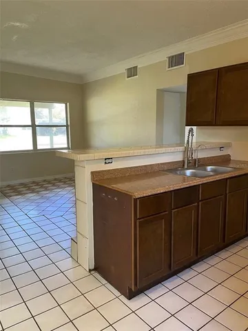 a kitchen with a sink and a mirror