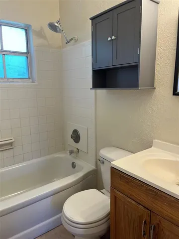 a bathroom with a sink a toilet and bathtub