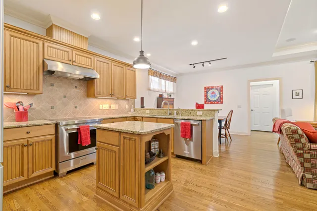 a view of a hallway with wooden floor and stairs