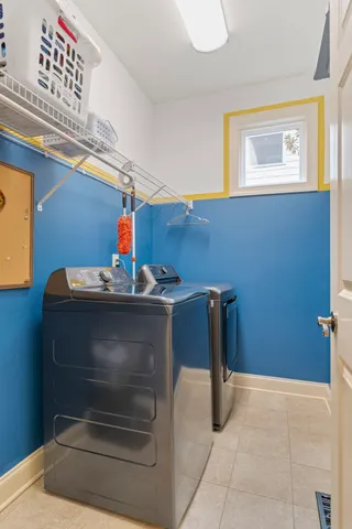 a living room with furniture and a chair