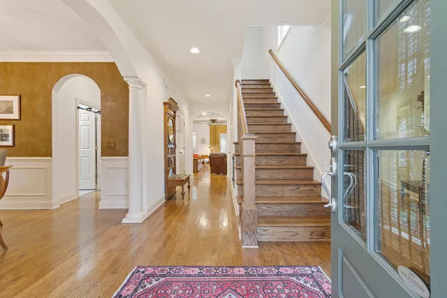 a living room with furniture a fireplace and a chandelier