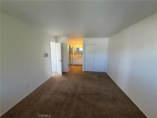a kitchen with a refrigerator a stove top oven and white cabinets