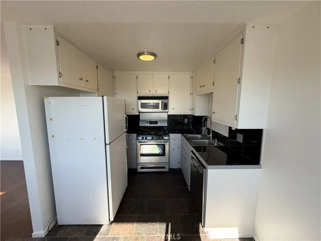 a bathroom with a double vanity sink and mirror with shower