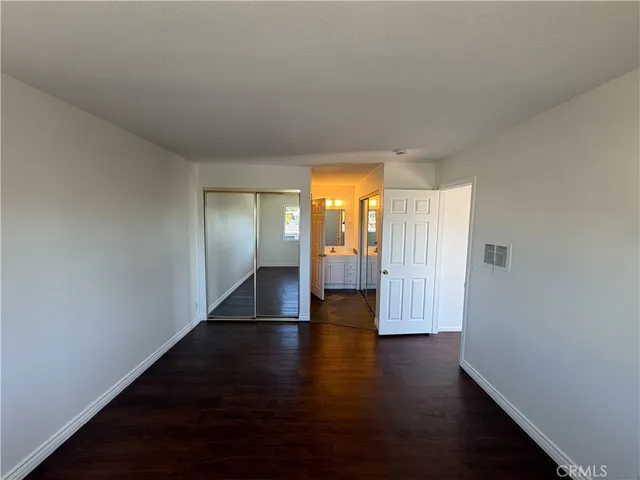 a view of a pathway of a house with wooden fence