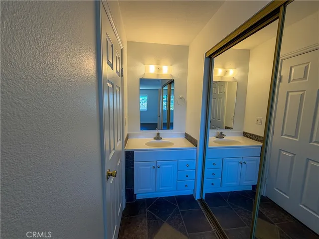 a view of a kitchen with a sink stove cabinets and empty room