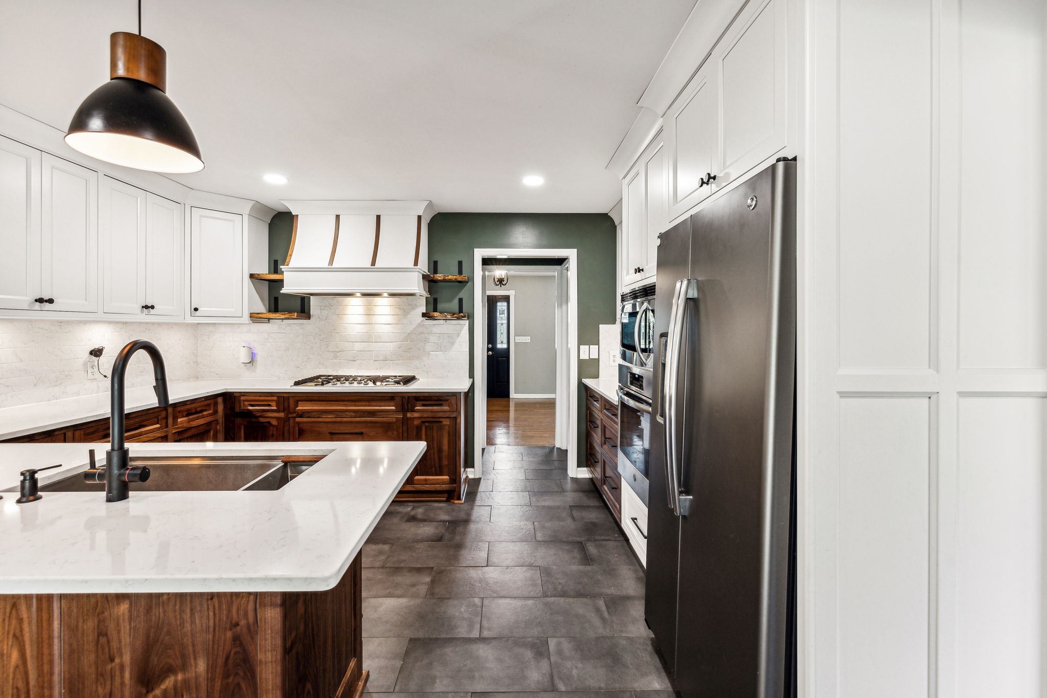 915 Woosley Road Tullahoma, TN 37388 - Photo 16 of 70 The kitchen has everything you need. Custom wood cabinets in modern two tone. Wood stain on bottom cabinets and white upper cabinets.